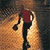 Pixelated static icon of a running stick figure with red torso, black limbs, and white accents against an orange-brown gradient background.