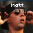 A pixelated image of a person wearing sunglasses and a dark cap, with text above the head changing across frames.