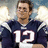 A pixelated image of a person in a dark blue sports jersey with white number 12, set against a red background with blue text reading "Tom Brady is love <3".