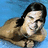 Pixelated image of a person with dark hair in a swimming pool, smiling, with red text overlays on black and gray backgrounds.