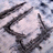 A static pixelated image shows a stylized dark shape resembling a dragon or serpent against a light, cloudy background with subtle blue and gray tones.