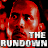 Pixelated image of a person with red-toned skin and dark eyes, overlaid by bold white text reading "THE RUNDOON" against a black background.