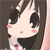 Pixelated cartoon-style character with large black eyes, pink cheeks, and dark hair, wearing a dark top with light-colored collar and red accents.