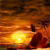A pixelated scene depicts a bright yellow sun at the center with orange and brown hues radiating outward, set against a dark brown background with a red silhouette on the right.