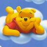 Static cartoon icon of a yellow bear lying on white clouds against a blue background, wearing red clothing and resting its head on one paw.