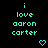 Pixelated cyan text on black background reads 'i love aaron carter' with two heart symbols below, one static and one animated.