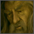 Pixelated static image of a male figure with light brown hair and beard, wearing dark clothing against a muted greenish-brown background.