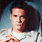 A pixelated image of a person with dark hair wearing a white shirt, positioned next to green text reading 'OriginalIcons.com' on a solid background.