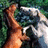 Pixelated image of two figures embracing with green foliage background, pink text overlays reading 'The White One', 'is so gonna win' on black field.