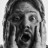 Black-and-white pixelated image of a person with long hair, wide eyes, and an open mouth showing teeth, set against a light background.