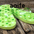 Green circular icons with white and green pixelated patterns on a wooden background, each labeled 'aoife' in black text.