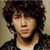 A pixelated image of a person with curly dark hair wearing a dark jacket over a light shirt, next to purple pixelated text reading "Sabrinas Lov 4Ever" on a white background.