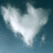 A heart-shaped cloud formation against a blue sky with subtle variations in brightness and position across four