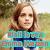 A woman with long brown hair in a grassy field, wearing a blue scarf and white top; text overlay reads "Mall loves Emma Watson".