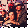 Group of people in a stylized photo with red and black background text, some wearing sunglasses and dark clothing.