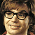 A pixelated contact sheet showing two frames of an animated icon featuring a character with brown hair and glasses on the left, next to green text reading "Original Icons .com" on a dark green background.