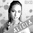 Pixelated grayscale image of a person with long dark hair, closed eyes, and a neutral expression, with 'AKO' text in the top-right corner.