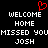 Black background with white pixelated text reading WELCOME HOME MISSED YOU JOSH and a red pixelated heart symbol above the text.