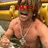 A shirtless man with a silver chain necklace sits on a golden throne-like chair, with red text above him changing across frames.