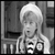 A black-and-white animated frame showing a person with light hair and a headband, next to a bright yellow panel with bold text "How Rudell!" in black letters.