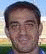 twelve individual head-and-shoulders portraits arranged in three and four , each showing a person in a blue and white striped shirt against an outdoor background