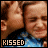 nine identical pixelated images showing two people kissing, each with 'KISSED' text below