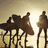 Silhouetted figures on poles against a gradient sky, with one figure holding a flag-like shape.