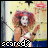 Pixelated image of a figure with red hair, white face paint, and a black-and-white checkered lower body, holding a guitar-like object against a light background with scattered colored pixels.