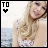six pixelated shows a woman with long blonde hair in a floral top against a blurred ocean background, each displaying one word of 'TO THE BEAT OF MY HEART' above a black heart symbol