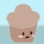 Pixelated brown muffin with pink cheeks and small black eyes, set against light blue background.