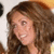A pixelated close-up of a person with long brown hair smiling, showing teeth and eyes in two side-by-side frames.