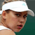 A pixelated close-up of a person wearing a white cap and dark sunglasses against a teal background.
