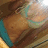 Pixelated close-up of a figure with brown hair and teal accents, partially obscured by low resolution.
