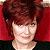 A pixelated contact sheet showing two frames of an animated buddy icon featuring a person with short red hair against a red background on the left and green text reading "Original Icons .com" on the right.
