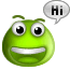 Green cartoon character with large eyes and antennae, smiling widely with a speech bubble saying "Hi".
