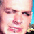 Pixelated close-up of a person's face showing eyes, nose, mouth, and partial cheek with visible pixelation and color blending.