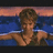 Pixelated image of a person with short brown hair in water, wearing dark swimwear against a sunset sky and blue sea background.