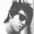 Black-and-white pixelated image of a person with dark hair and sunglasses, accompanied by text elements including 'ALLIE MARIE ORLANDO' and 'LOVES<3' on the left side.