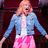Pixelated image of a person in blue denim jacket and pink skirt with text on right side.