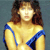 Pixelated static image of a woman with brown hair wearing a yellow top with blue straps against a gray background.