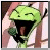 Static pixelated cartoon of a green plant-like creature with a wide open mouth, visible tongue, and closed eye against a blurred background.