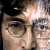 Pixelated close-up of a person with round glasses and dark hair, showing slight variations in facial expression across frames.