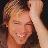 Pixelated close-up of a person with light brown hair, closed eyes, and a neutral expression against a blurred background.