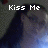 Pixelated image showing two figures in close proximity with text "Kiss Me" overlaid in white block letters.