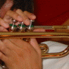 Four- shows a person playing trumpet, close-up face with red lips, black-and-white portrait, and empty gray space