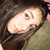 A pixelated image of a person with long dark hair and light skin, wearing a green top, with text overlay reading SEXY!k3.