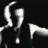 Animated sequence of a figure in dark clothing with light hair performing repetitive arm movements against black background.