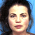 A pixelated mugshot-style image of a person with dark hair against a blue background, accompanied by green text reading "Yasmine Bleeth" and "Celebrity Original MugshotsIcons.com" on a white striped backdrop.