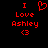 Red pixelated text and symbols on black background: 'I Love Ashley <3' with a heart symbol replacing the 'love' word in one view.