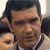Static 50x50 pixel icon showing a close-up of a man's face with dark hair and light skin, wearing a white shirt and dark tie against a blurred background.